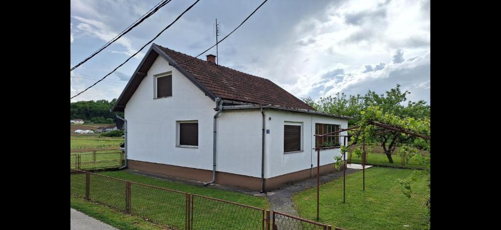 a small white house with a brown roof at Stefin kutak HOME in Bosanski Novi