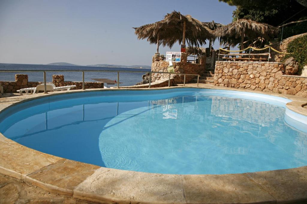 a large blue swimming pool next to the ocean at GLamping tents Adriatic - Orebic in Orebić