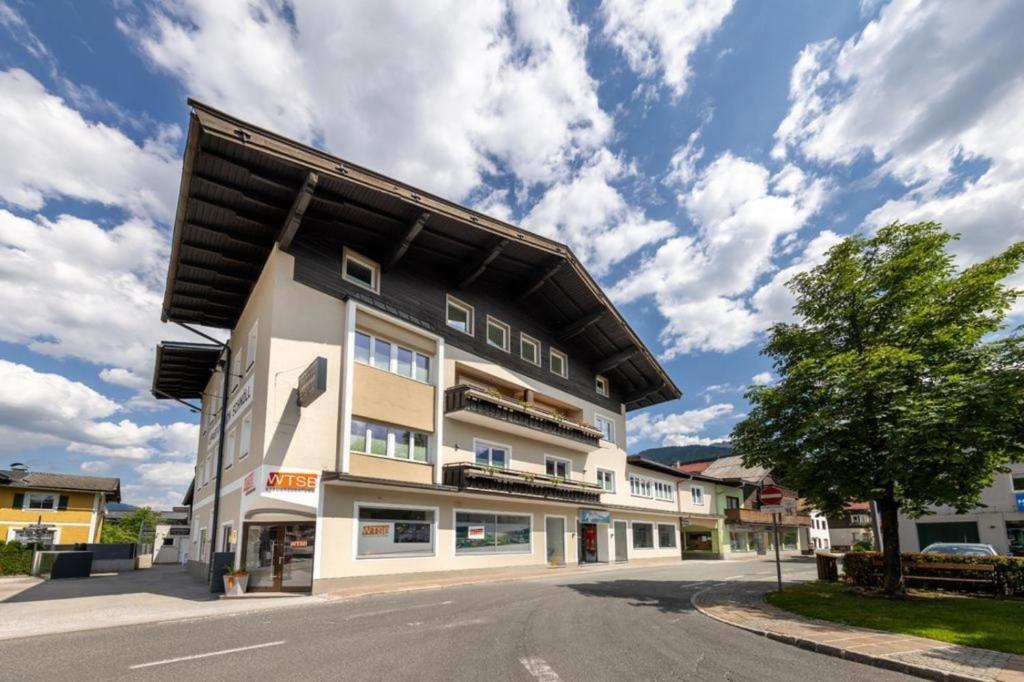 a building with a roof on the side of a street at Haus Schnöll Top 7 in Mittersill