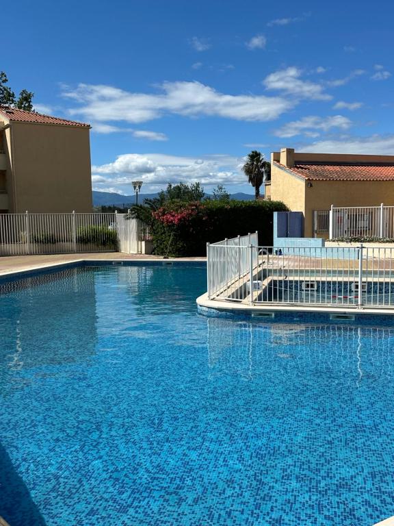 une grande piscine avec de l'eau bleue dans l'établissement T2 RDC à Canet en Roussillon Europa 4 pers ,piscine,clim, tennis, parking, à Canet