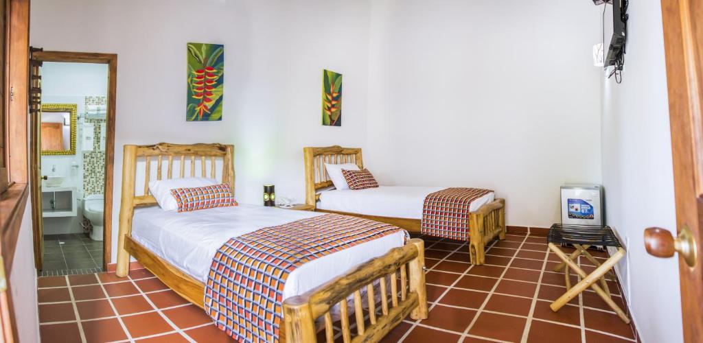Postel nebo postele na pokoji v ubytování Hotel Brisas La Gaviota Mariquit-Tolima