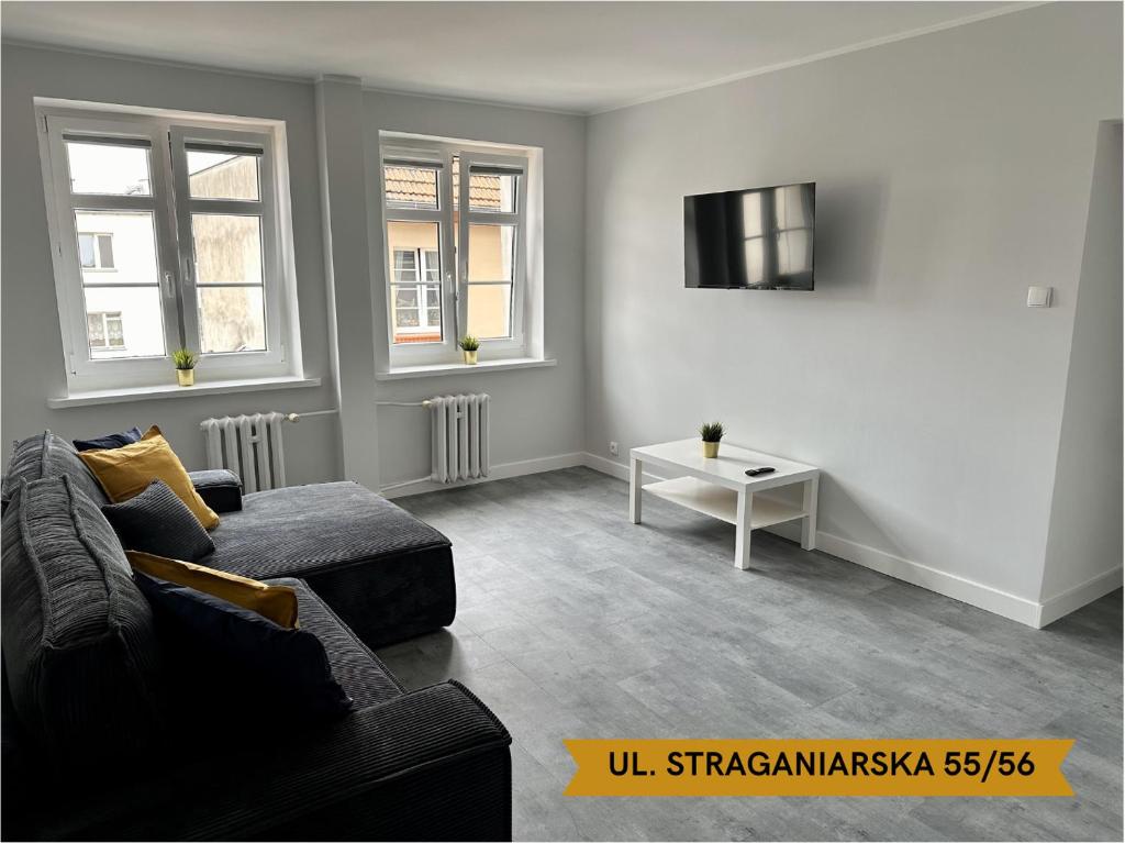 Televízia a/alebo spoločenská miestnosť v ubytovaní Lunette Apartments