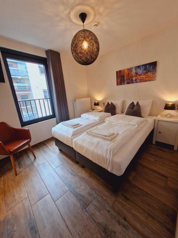 Postel nebo postele na pokoji v ubytování Hotel Ladeuze