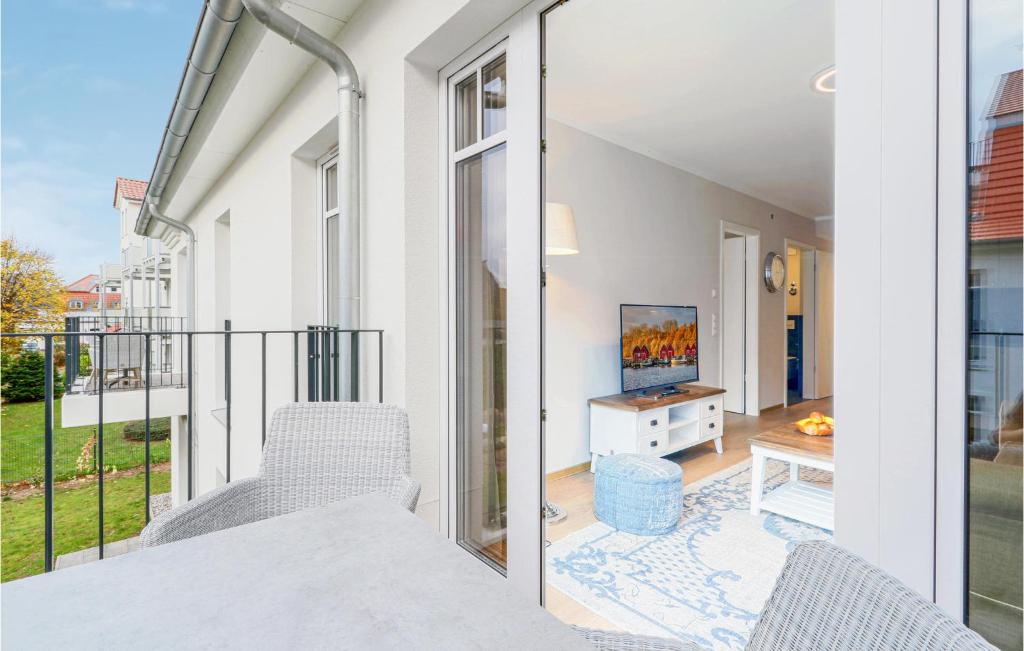 a balcony with a table and chairs and a television at Baltischer Hof Apartment 39 in Boltenhagen
