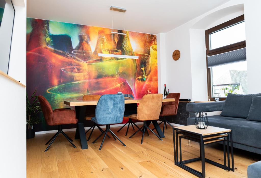 a living room with a table and chairs at Ferienwohnung Mosel-Saar-Ruwer in Bernkastel-Kues