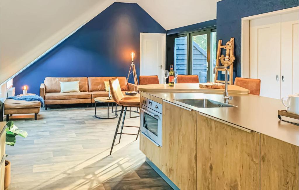 a kitchen and living room with a couch at Stunning Apartment In Schagerbrug in Schagerbrug