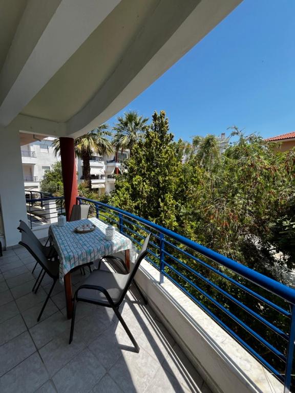 a patio with a table and chairs on a balcony at Sofia's house in Possidi