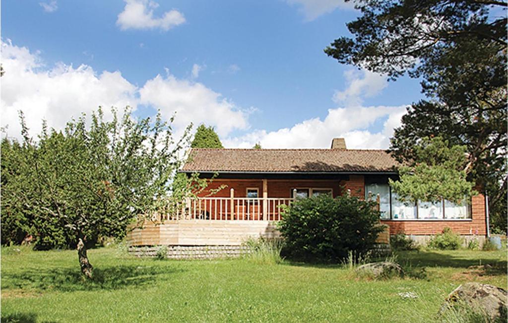 a small house in a yard in front of a house at Two-Bedroom Holiday Home In Nattraby in Bredavik