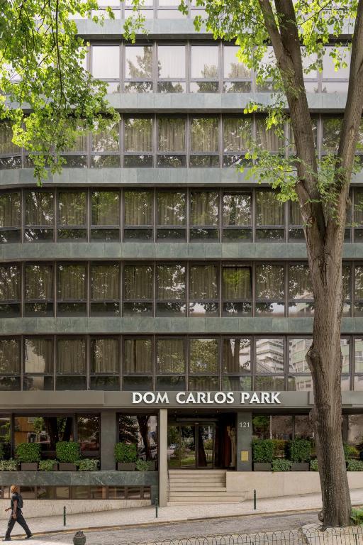a man walks past the front of a building at Hotel Dom Carlos Park in Lisbon