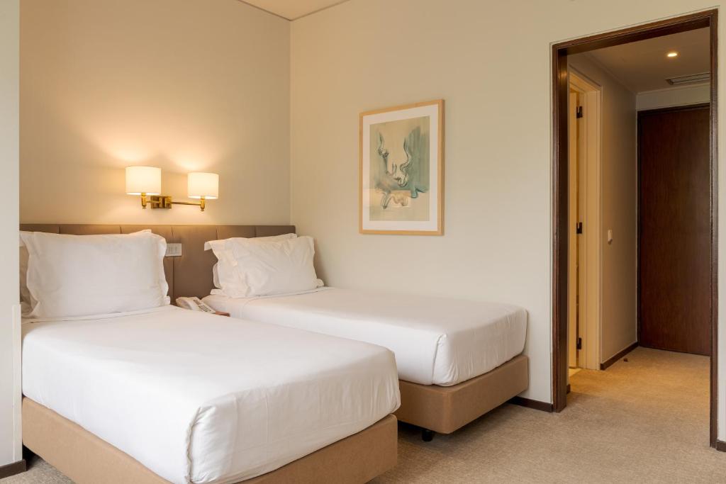 Postel nebo postele na pokoji v ubytování Hotel Dom Carlos Park