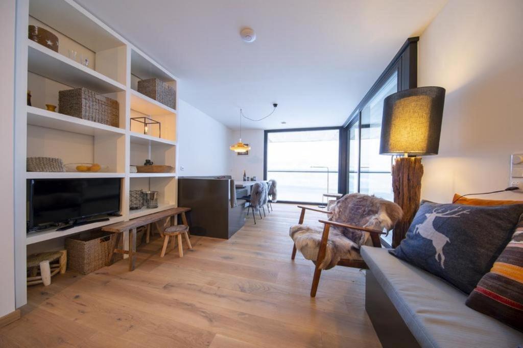 a living room with a couch and a table at Edelweisshaus Top 14 in Königsleiten