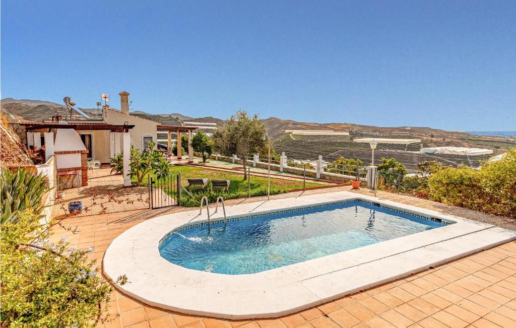 a swimming pool in a yard with a house at Nice Home In Velez - Malaga With Wifi in Vélez-Málaga