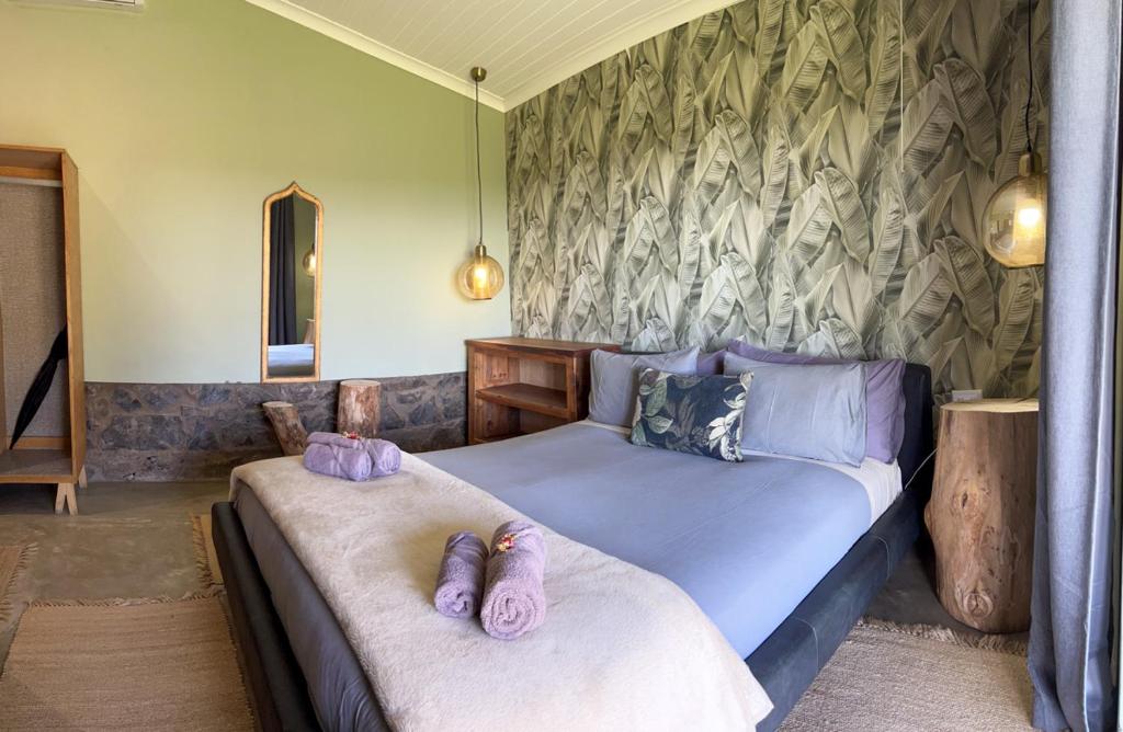 a bedroom with two beds with slippers on them at Tzamenkomst River Lodge in Colesberg
