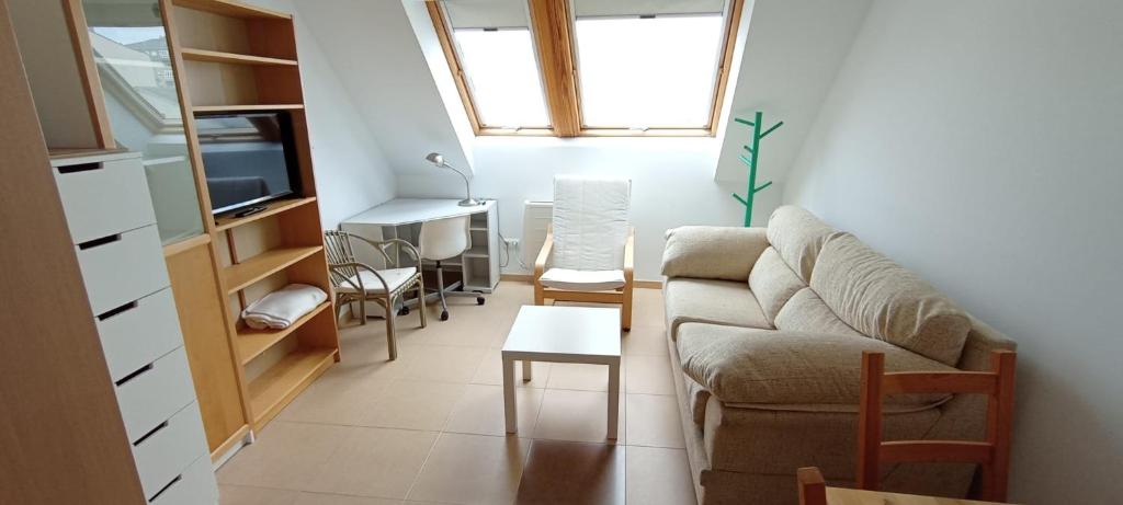 a living room with a couch and a table at EnBURELA Confort y Relax in Burela de Cabo