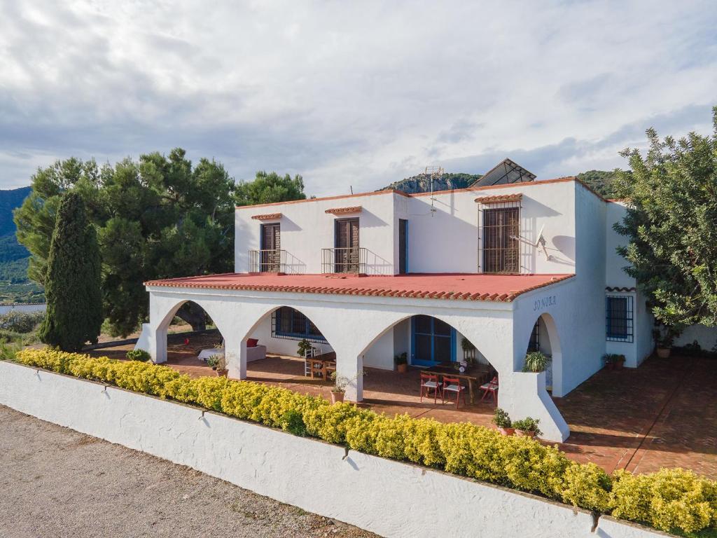 a large white house with a red roof at House -Sleeps 8-Natural Pool-Pet Friendly in Artana