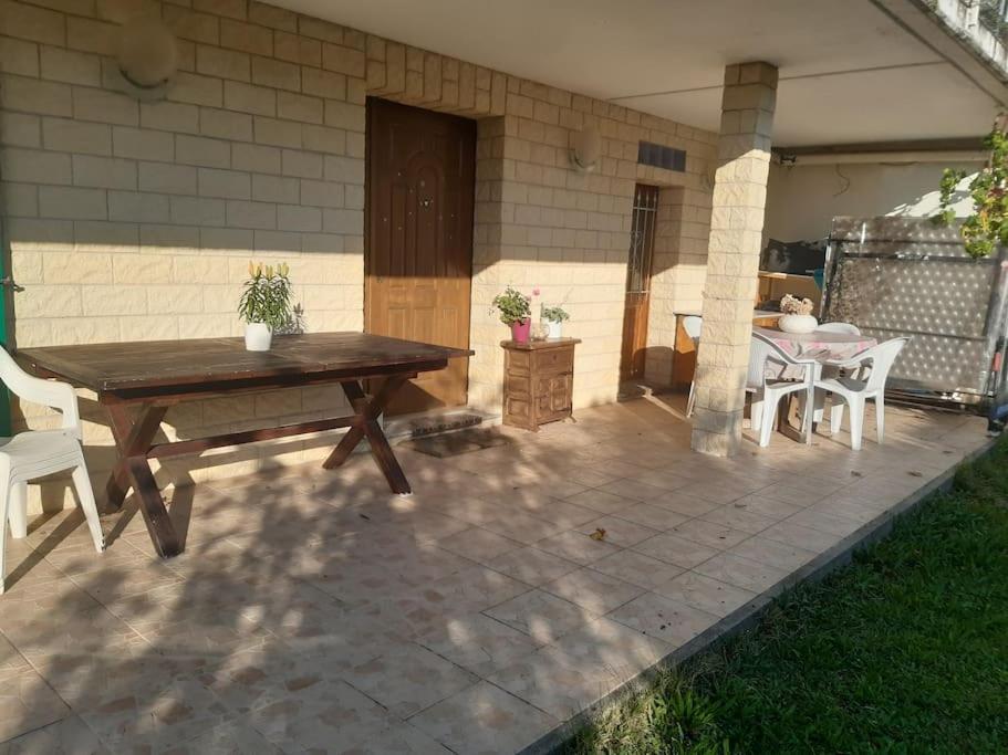 a wooden table and chairs on a patio at Appartement avec jardin privé à Montreux 100mt du lac in Montreux