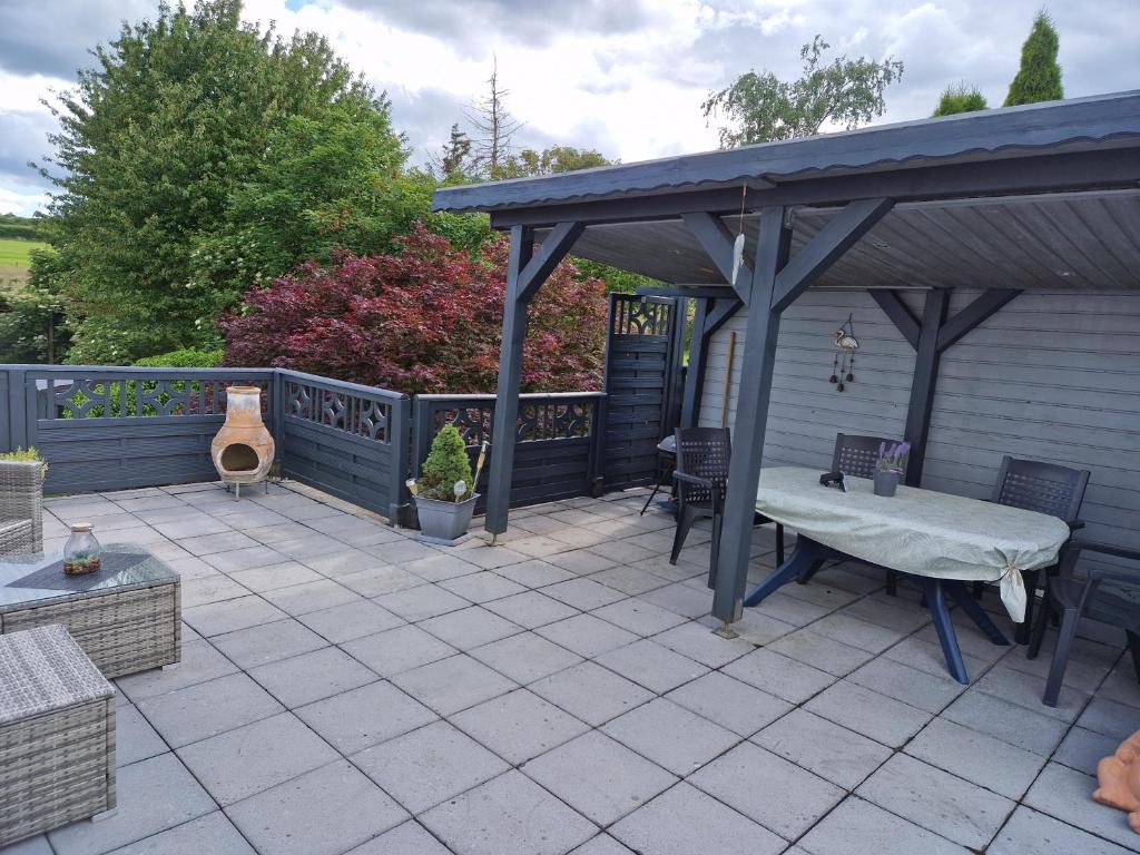 a patio with a picnic table and a pavilion at Ferienwohnung Parkblick Medebach in Medebach