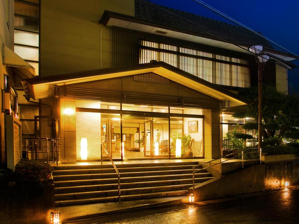 a building with stairs in front of it at night at Asahiro in Minabe