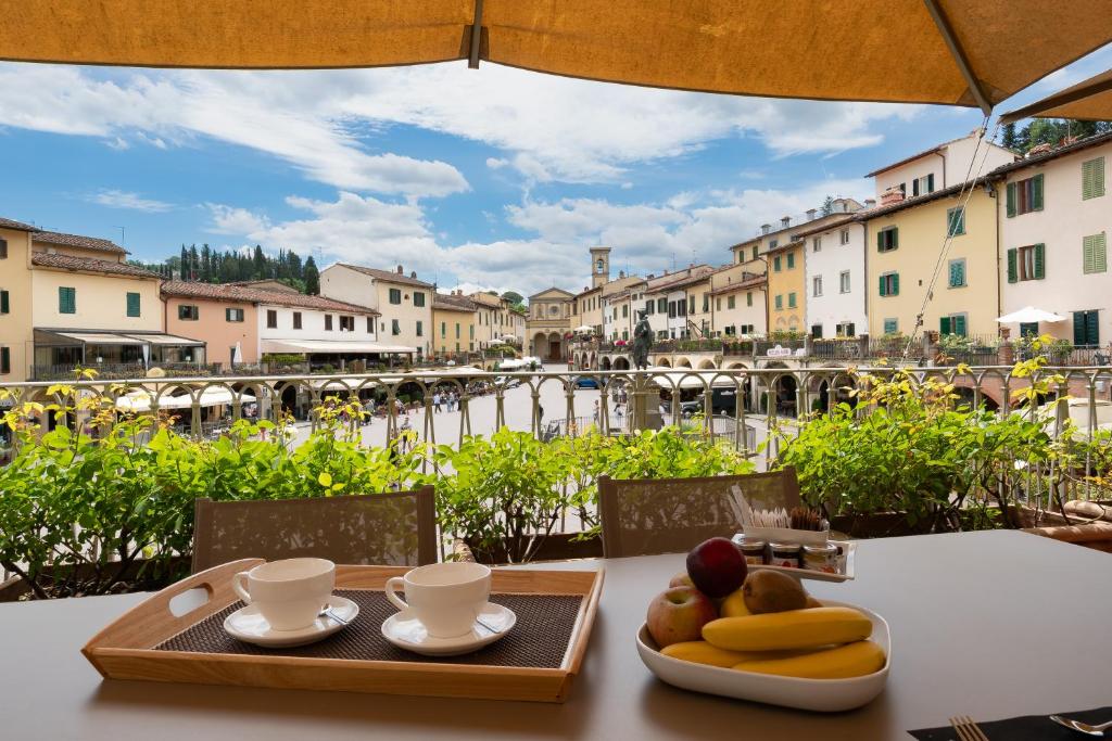 a table with a tray of fruit and coffee cups on it at Suite Greve in Chianti in Greve in Chianti