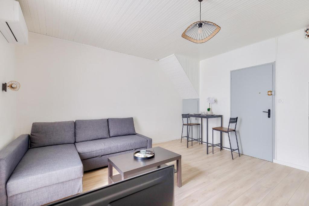 un salon avec un canapé et une table dans l'établissement Appartement pour 2 quartier de La Chaume, à Les Sables-dʼOlonne