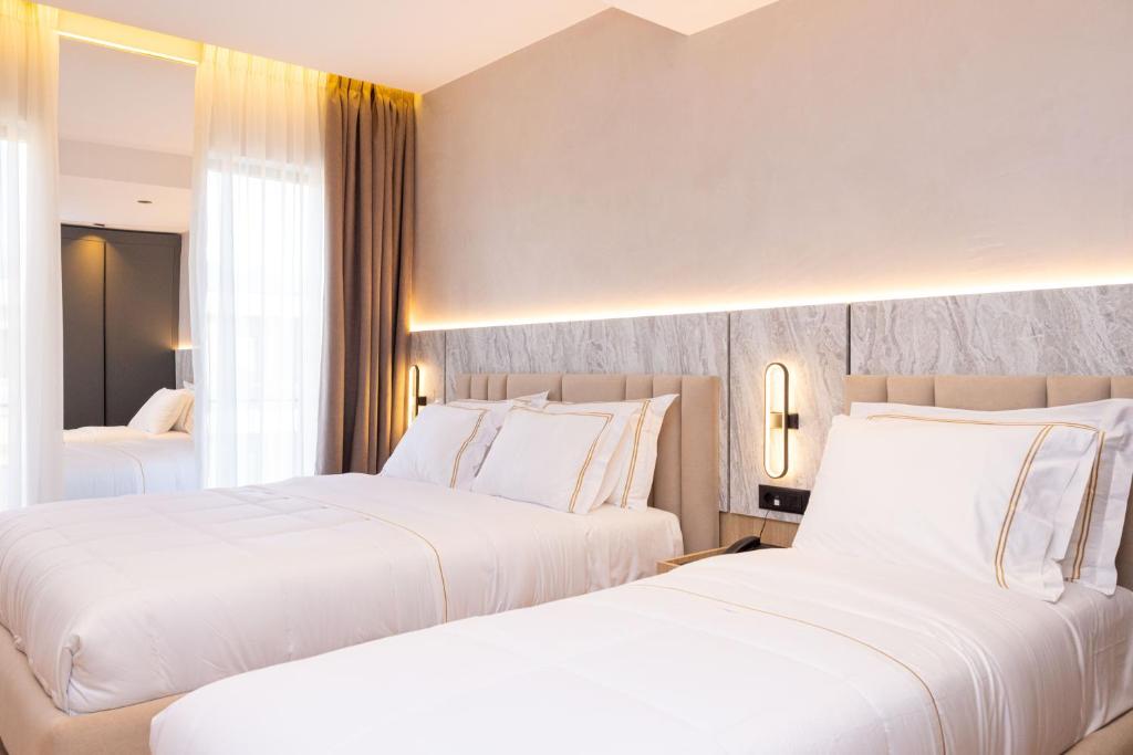 Postel nebo postele na pokoji v ubytování Tris3 Hotel