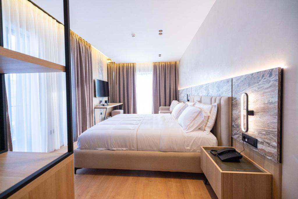 Postel nebo postele na pokoji v ubytování Tris3 Hotel