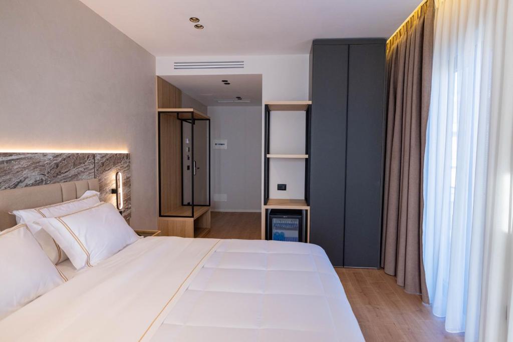 Postel nebo postele na pokoji v ubytování Tris3 Hotel