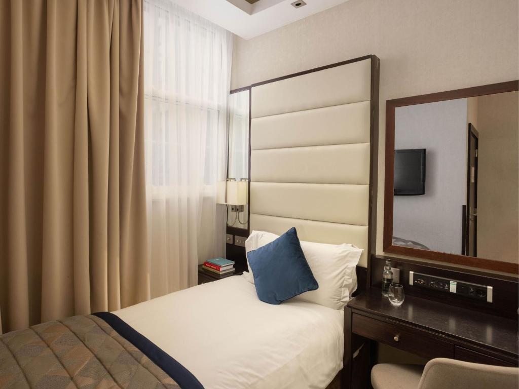 a hotel room with a bed and a mirror at Montcalm Brewery, London City in London