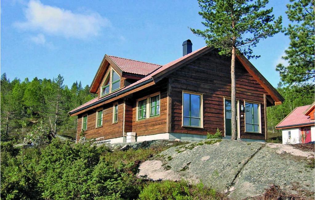 a wooden house sitting on top of a hill at 5 Bedroom Awesome Home In Kvinlog in Stakkeland