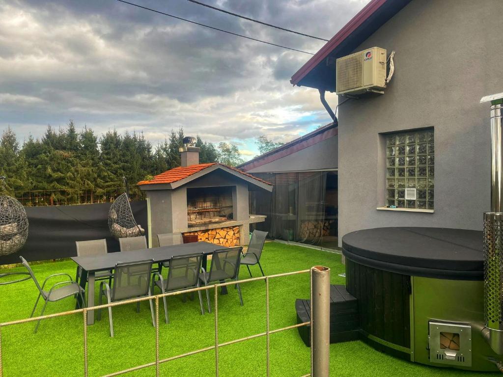 a backyard with a table and chairs and a grill at Kuća za odmor Mariola in Karlovac
