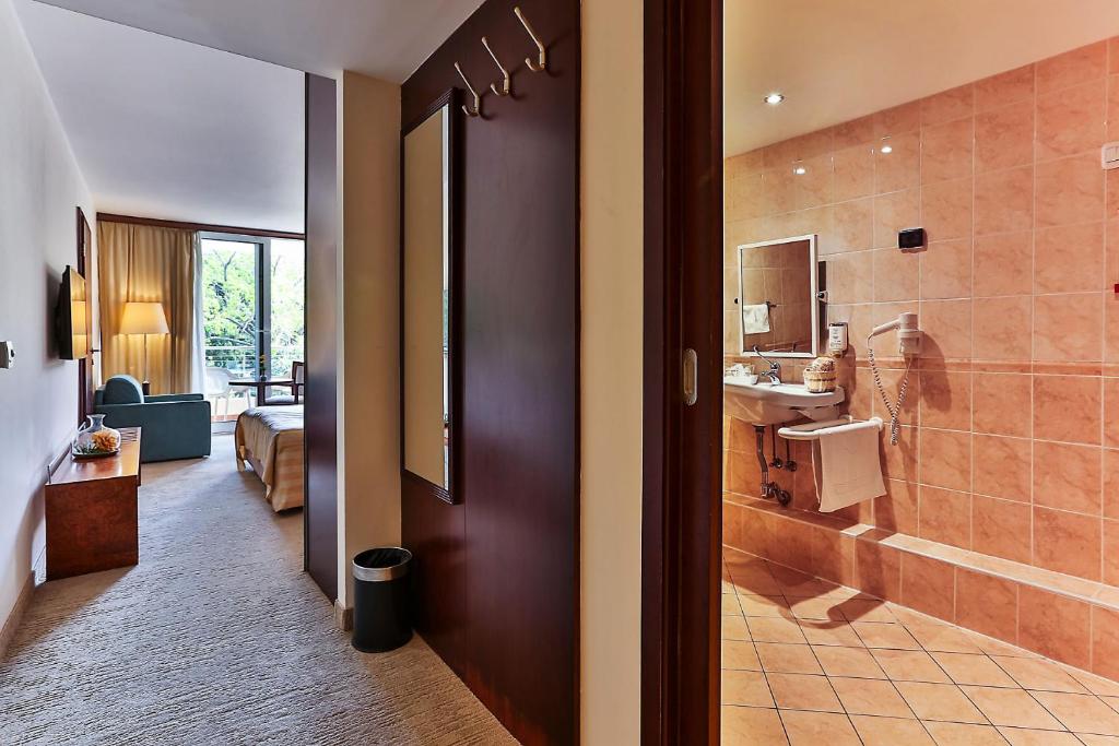 a bathroom with a shower and a sink and a toilet at Hotel Princess in Bar