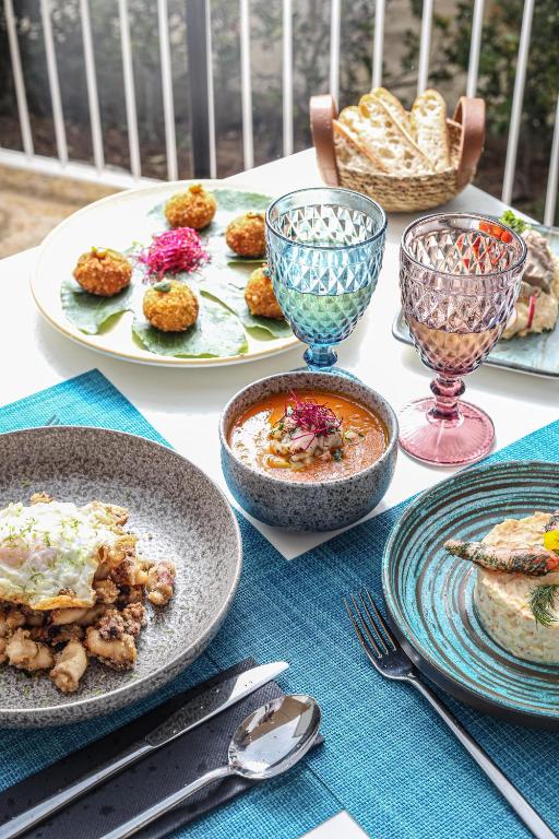 a table with plates of food and bowls of food at Inmood Aucanada 4 Sup in Port d'Alcudia