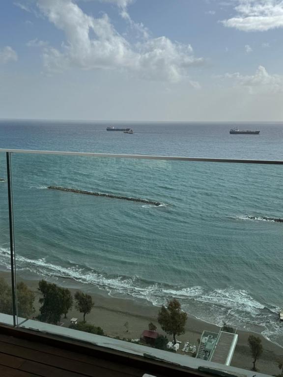 a view of the ocean with two ships in the water at Olympic Residence Deluxe Apartments in Limassol