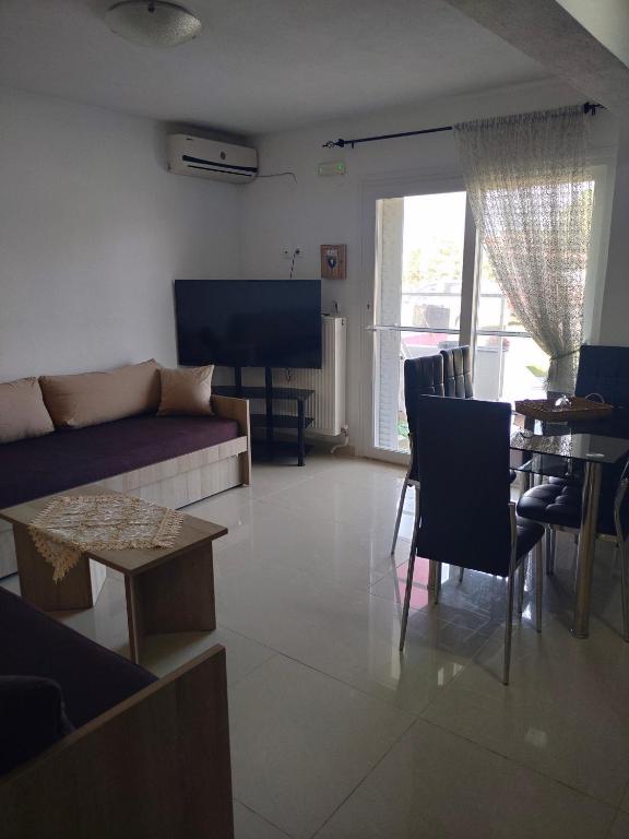 a living room with a couch and a table at Vigla House in Sykia Chalkidikis