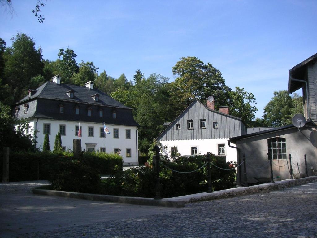 a group of white buildings on a street at Hammerschloss Unterklingensporn in Naila