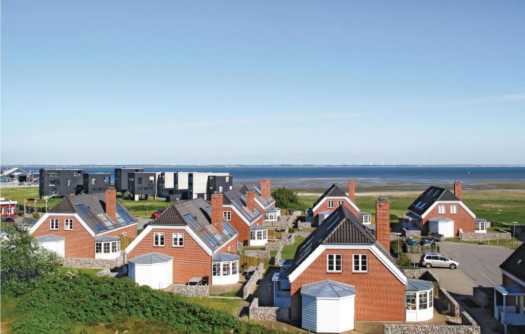 a group of houses on a hill near the ocean at Holiday Home Sdr Frankel Rømø Denm in Havneby