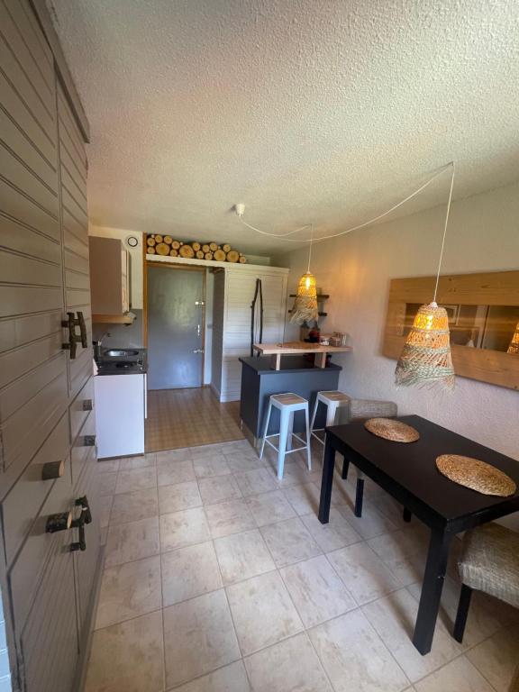 una cucina e un soggiorno con tavolo in una camera di le jaillet a Megève