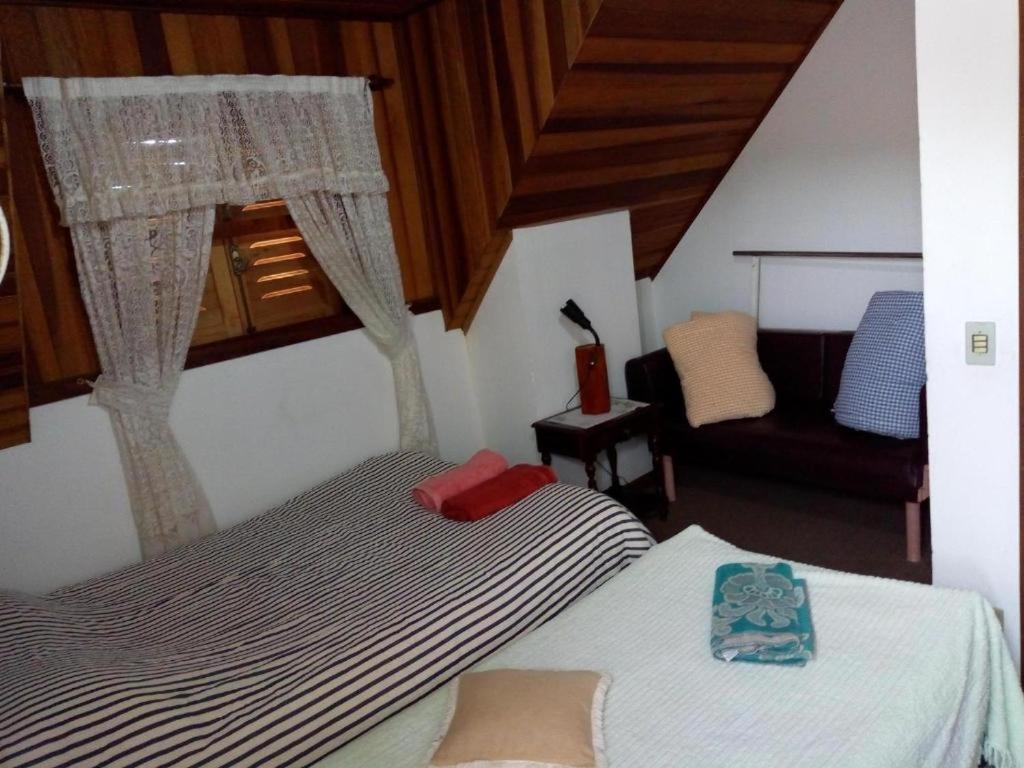 Cama ou camas em um quarto em Acomodação Flor Liz