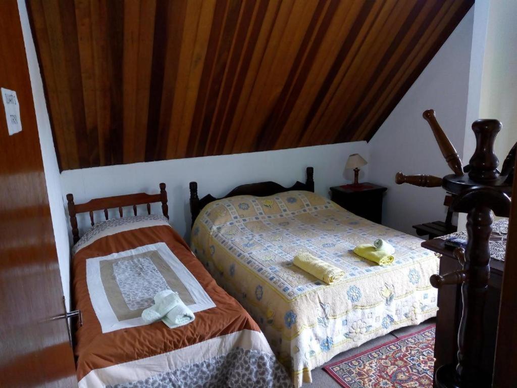 Cama ou camas em um quarto em Acomodação Flor Liz