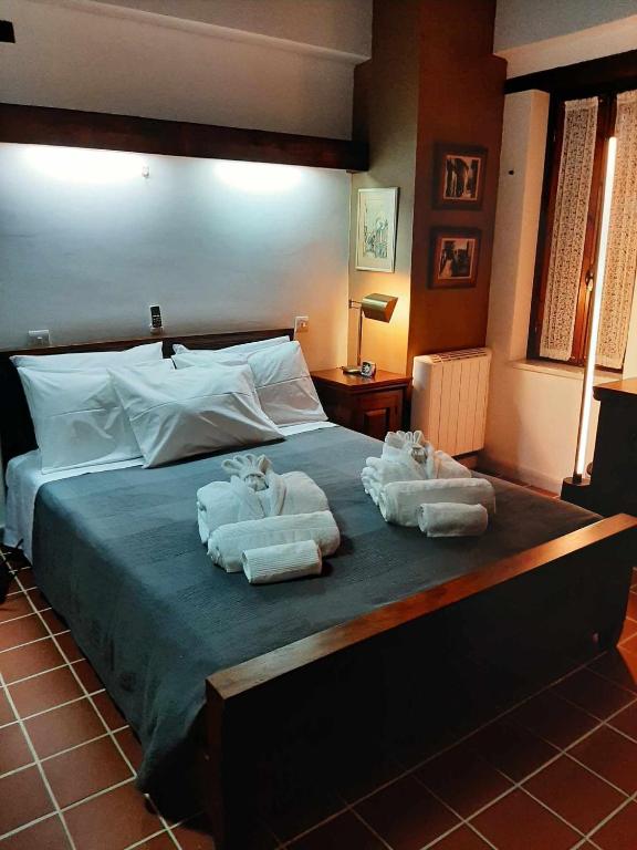 a bedroom with a bed with towels on it at FIKARDOU ALMOND PARK in Phikardhou