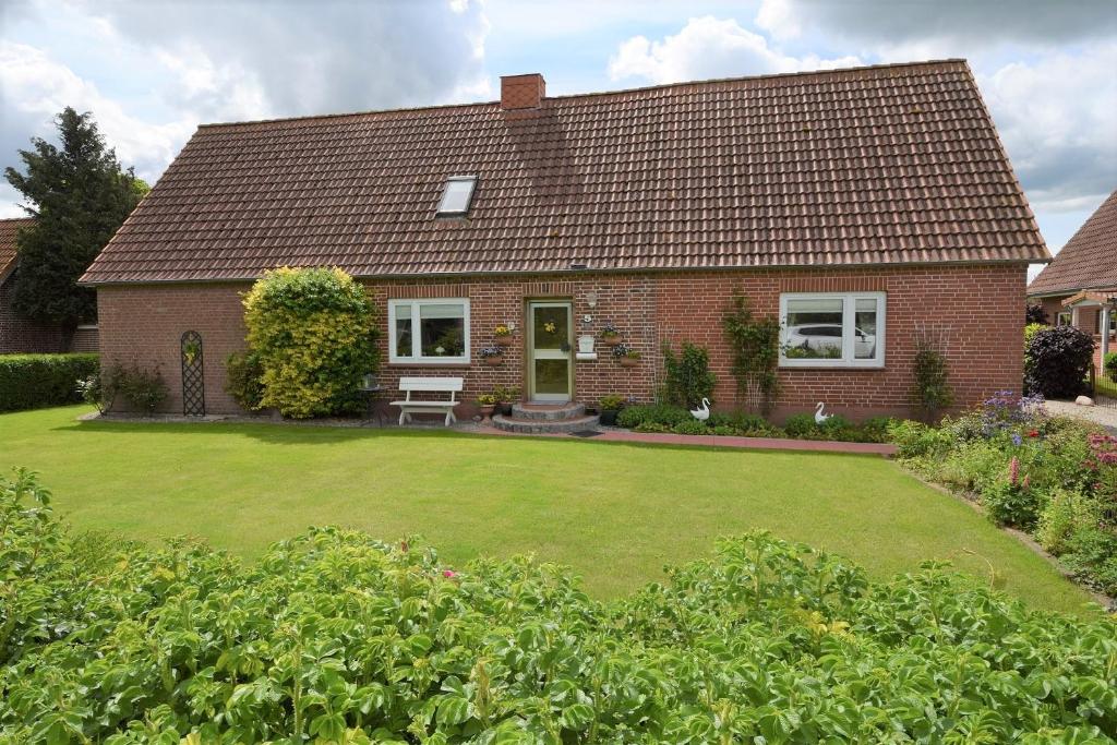 a red brick house with a large yard at Haus Steinkamp in Blekendorf