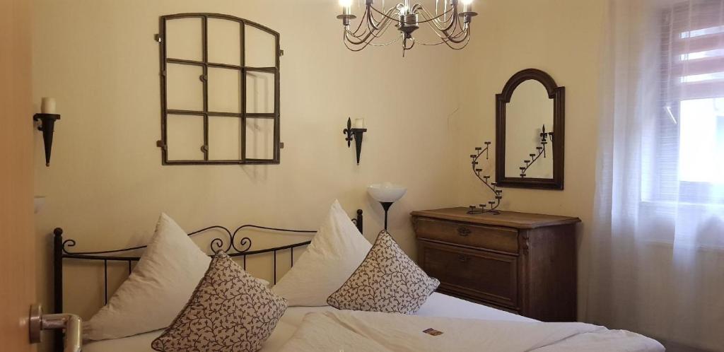 a bedroom with a bed with pillows and a mirror at Ferienhaus für 7 Personen ca 90 m in Marschacht, Hamburg und Umgebung in Marschacht