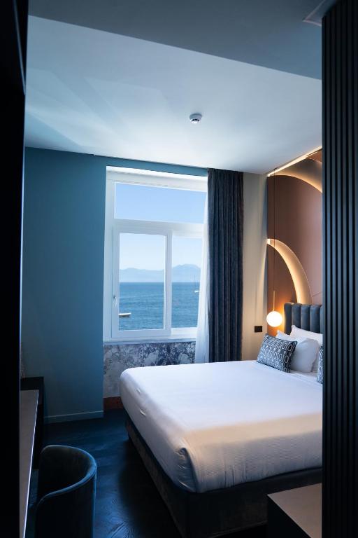 Postel nebo postele na pokoji v ubytování Relais sul Mare Boutique Hotel