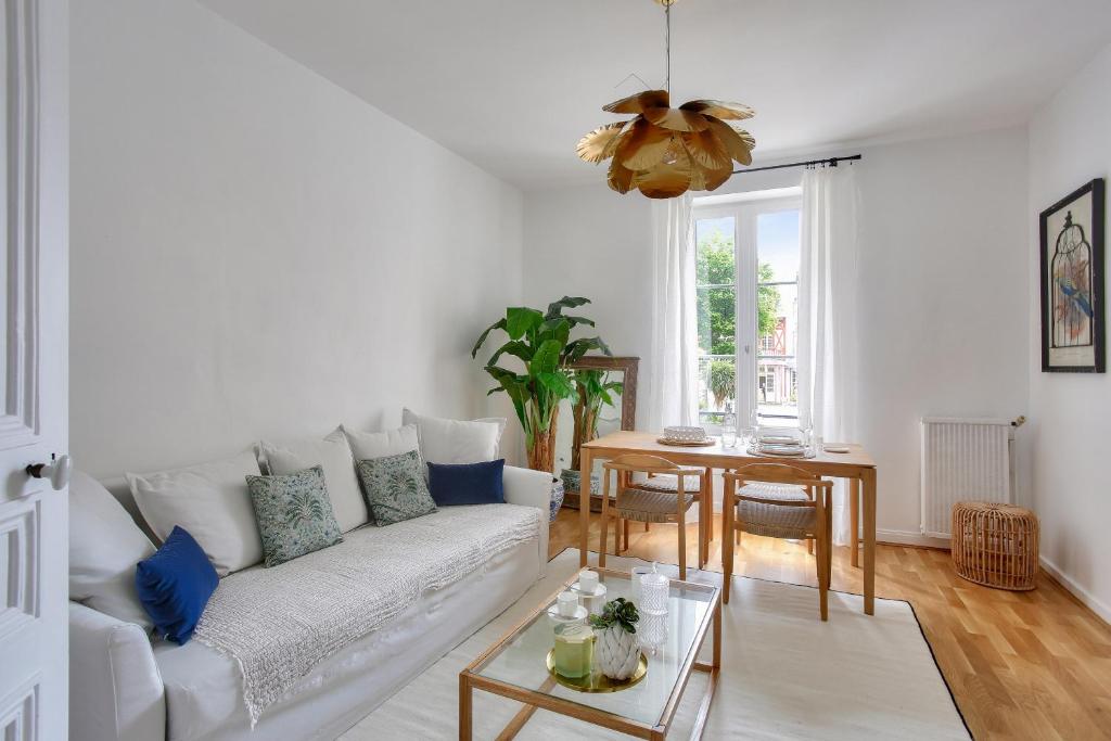 un salon avec un canapé blanc et une table dans l'établissement Appart hyper centre - 270m de la plage de l Ecluse, à Dinard