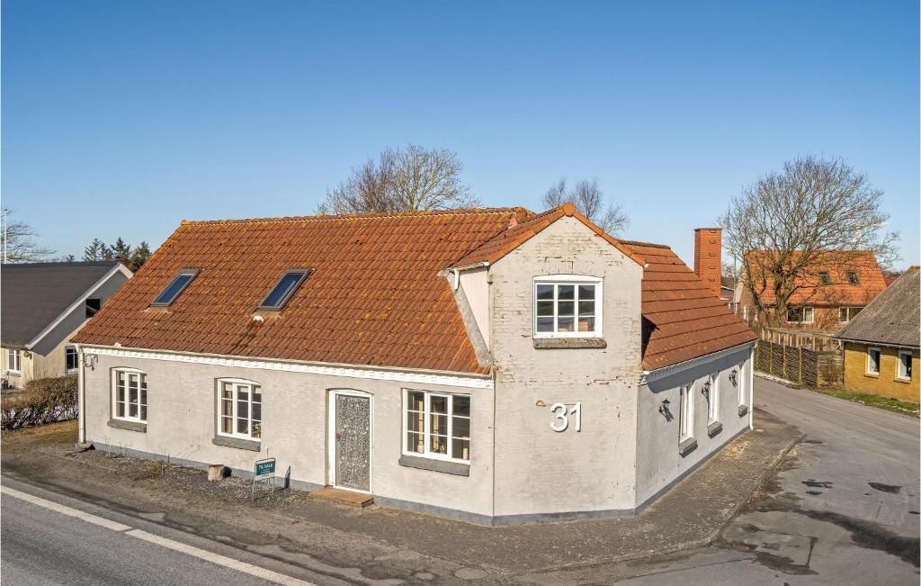 a white house with an orange roof on a street at 4 Bedroom Pet Friendly Home In Spøttrup in Spottrup