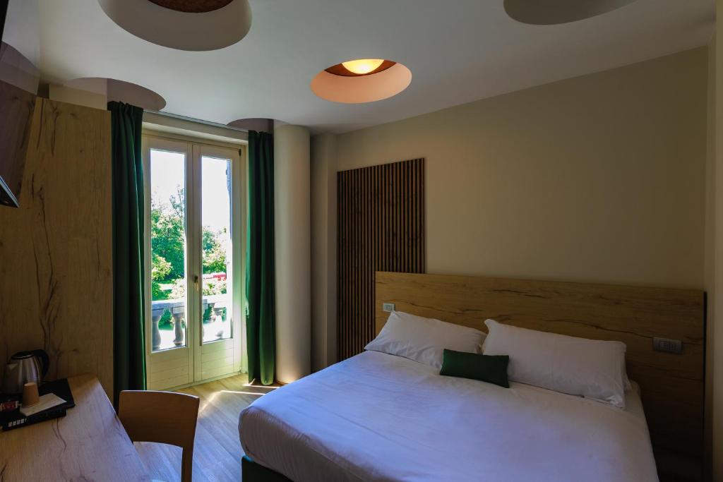 Postel nebo postele na pokoji v ubytování Botanique Hotel Vergani