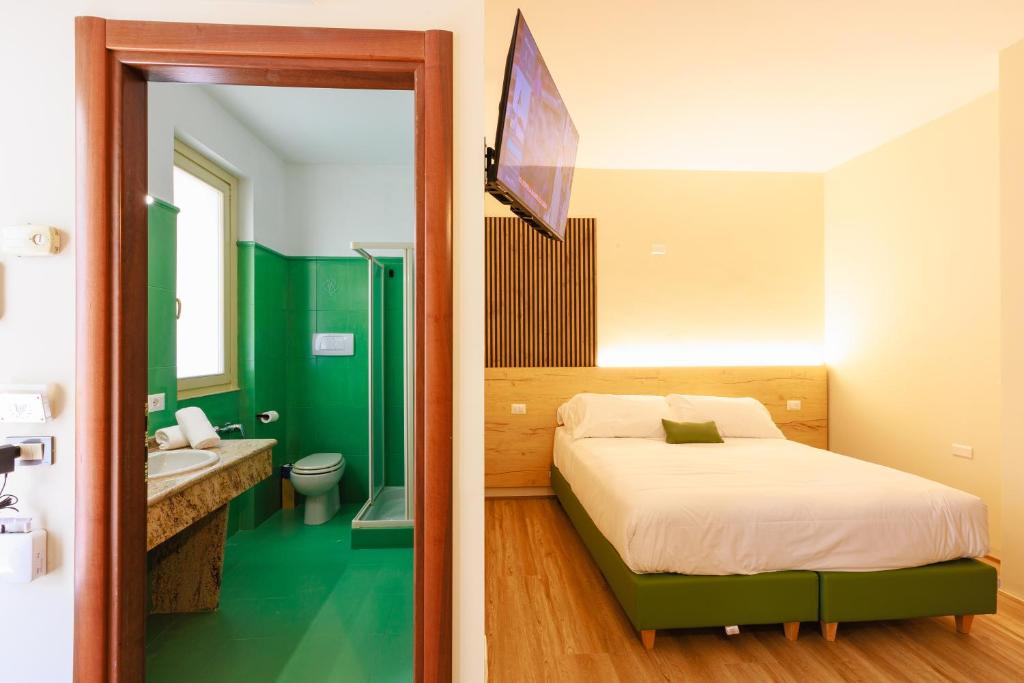 Postel nebo postele na pokoji v ubytování Botanique Hotel Vergani