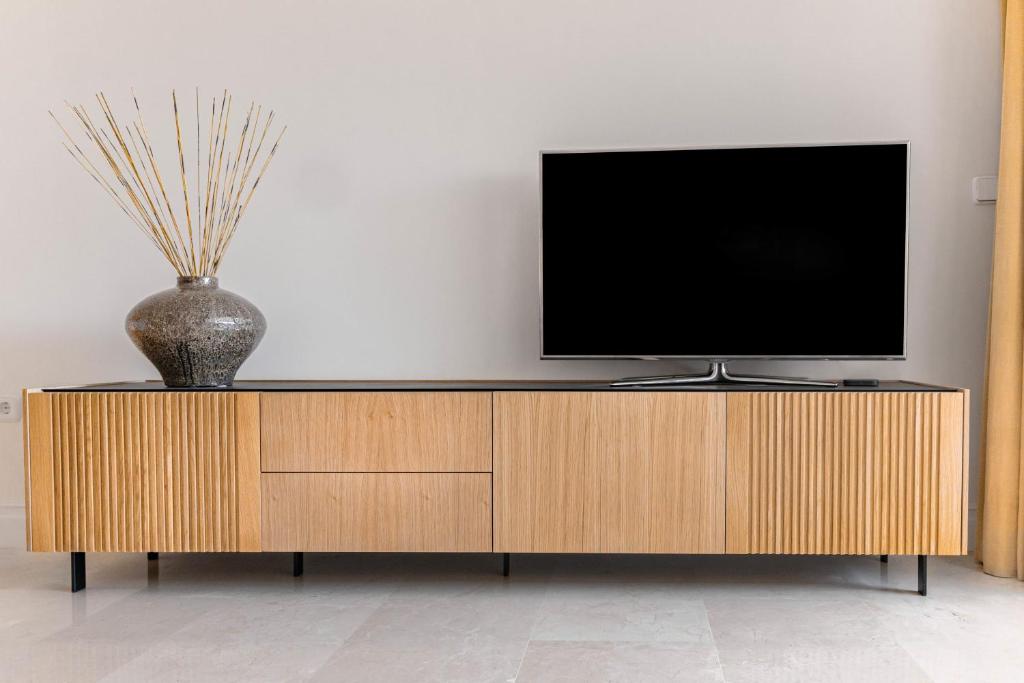 A television and/or entertainment centre at BEACHFRONT GOLDEN MILE PUENTO ROMANO SEA VIEW WIFI