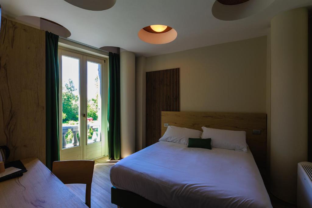 Postel nebo postele na pokoji v ubytování Botanique Hotel Vergani