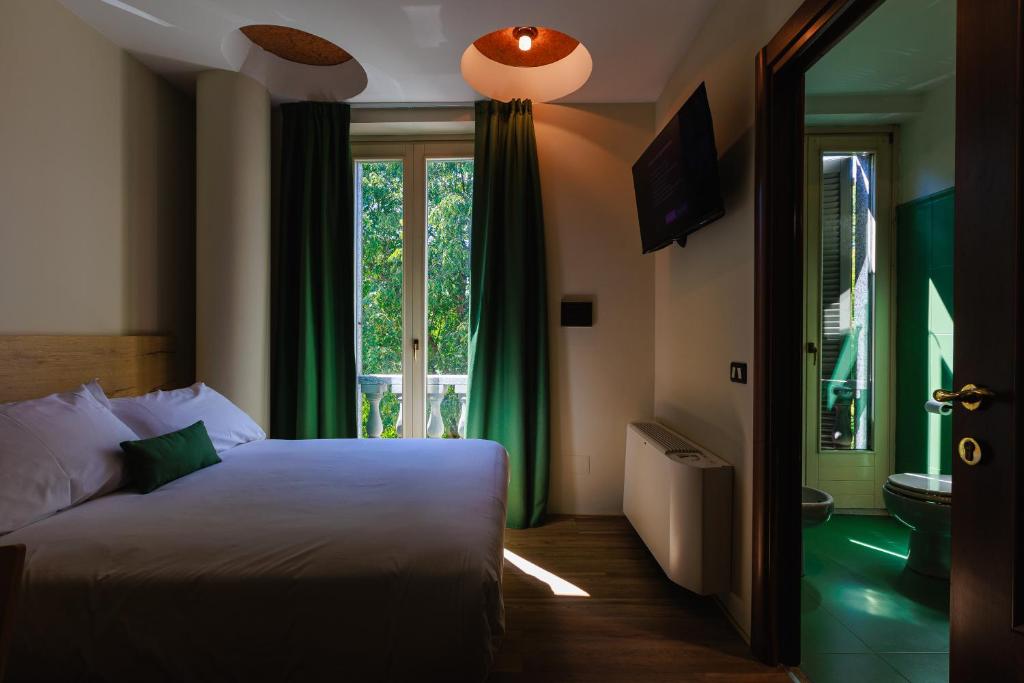 Postel nebo postele na pokoji v ubytování Botanique Hotel Vergani